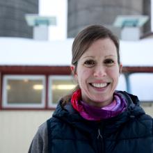 A Canadian dairy farmer in front of a barn