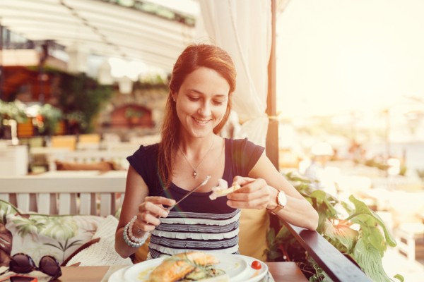 A woman enjoys a meal