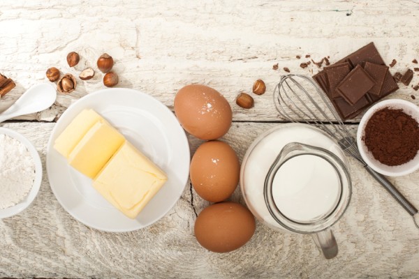 Butter and other baking ingredients on a wooden counter. 