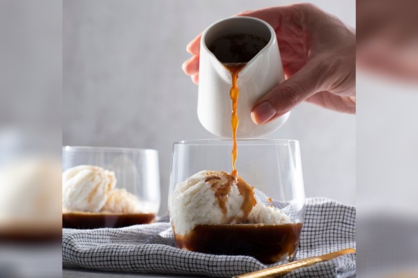 Glass of vanilla ice cream topped with fresh espresso for a classic Canadian dairy affogato.