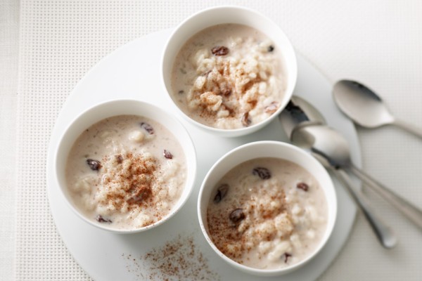 Creamy rice pudding in bowls, sprinkled with cinnamon, made with Canadian milk and table cream.