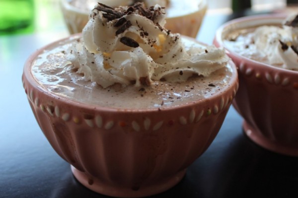 A tall glass of the best frozen hot chocolate, topped with whipped cream.