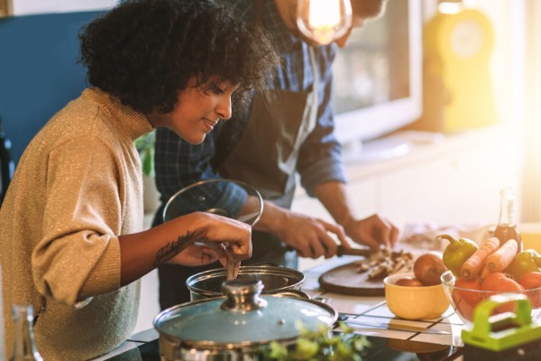 Couple meal planning and cooking together