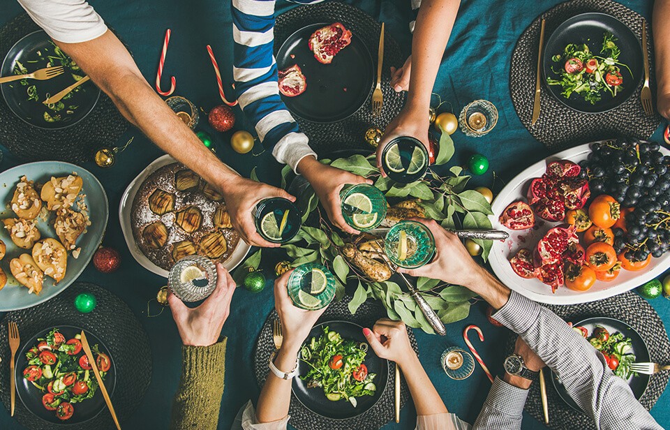 Friends and family gathering around a table to share a meal