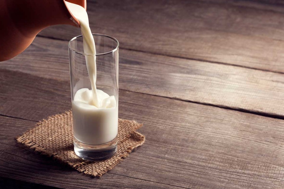 Glass of milk being poured.
