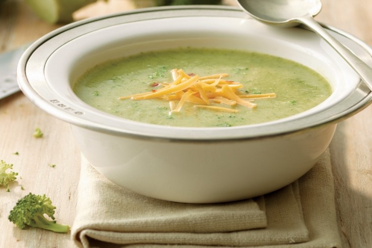 Bowl of broccoli cheddar soup with melted cheese on top