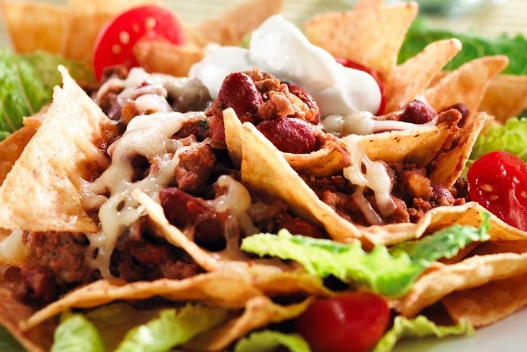 Taco salad with seasoned beef, beans, Canadian cheese, lettuce, and crispy tortilla chips
